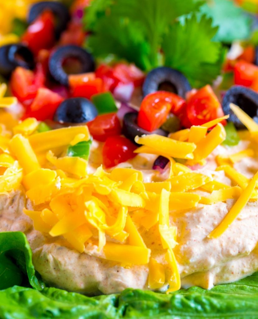 Fiesta Taco Dip. A quick an easy Mexican appetizer. Perfect recipe for game day as well as parties, gatherings and Cinco de Mayo celebrations.