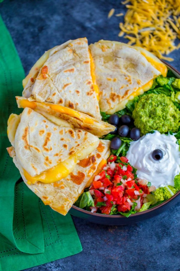 Tex-Mex Cheese Quesadillas served with sides of pico de gallo, sour cream, guacamole and black olives.