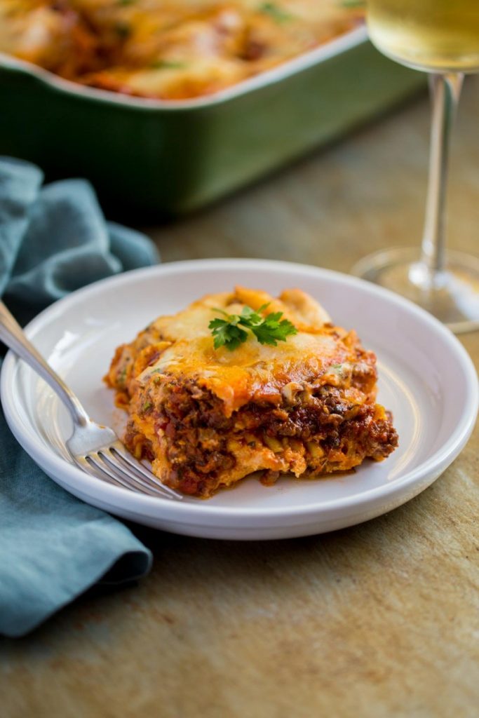 Easy lasagna recipe shown on a plate with fork.
