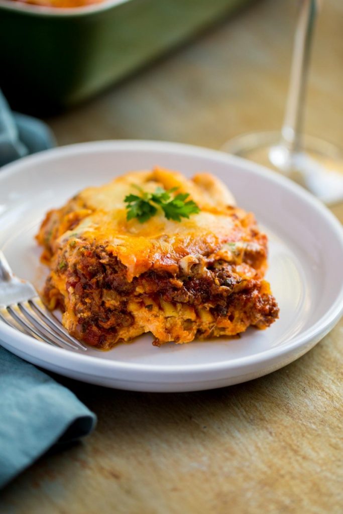 Legendary Meat Lasagna served with a glass of wine.