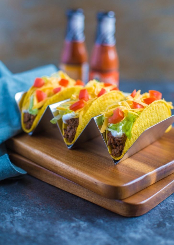 Ground Beef Tacos displayed in a special taco holder along with Taco Bell hot sauce.