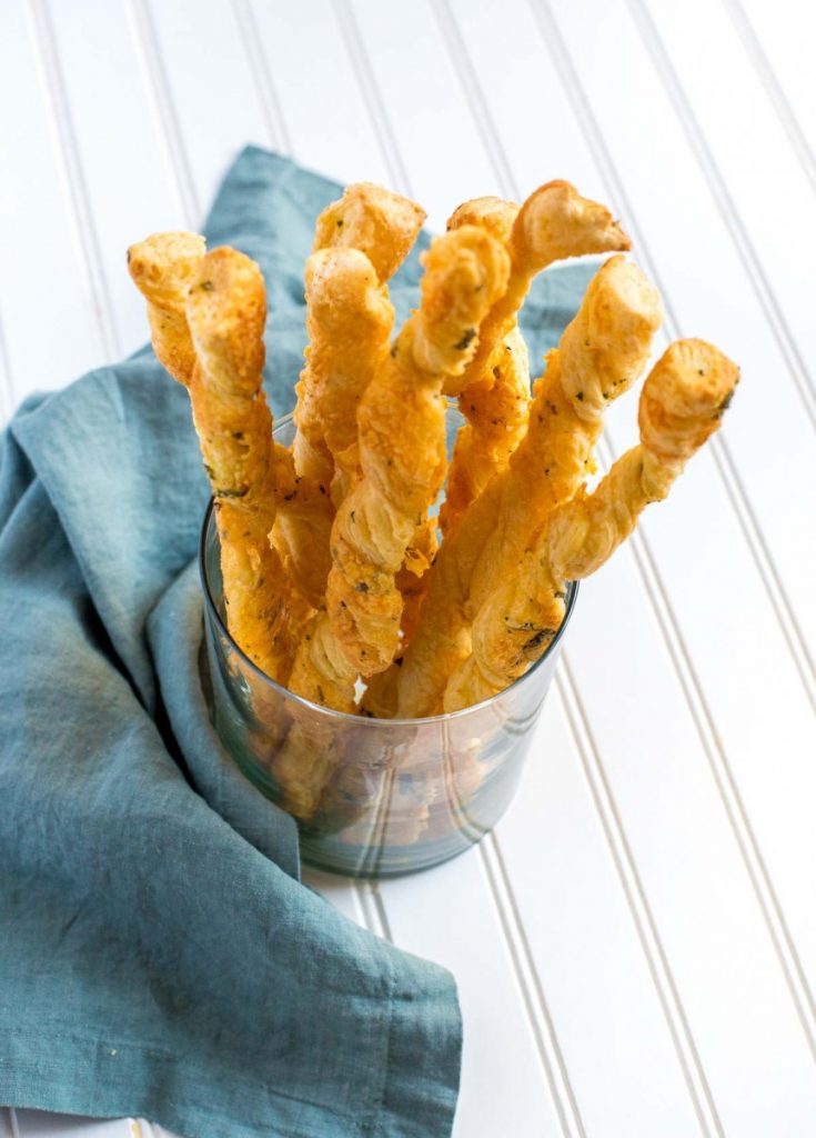 Puff Pastry Cheese Straws in a glass jar.