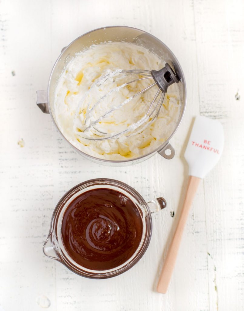 Ingredients for making chocolate mousse cups: bowl of whipped cream and bowl of chocolate ganache.