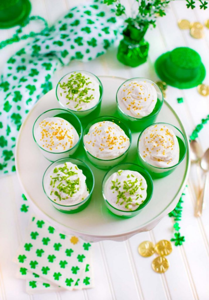 Jello in a cup desserts sprinkled with green jimmies and edible gold stars.