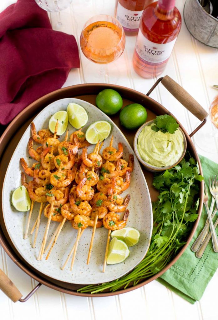 Grilled shrimp skewers served with avocado dipping sauce.