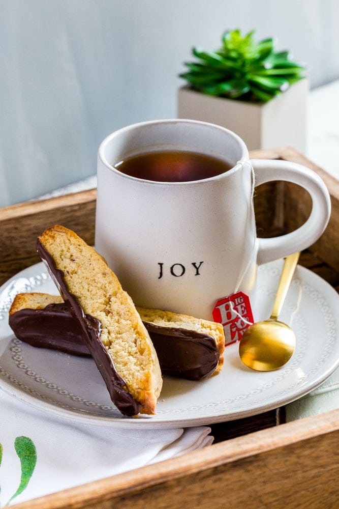Two pieces of Italian Biscotti with bottoms coated in chocolate enjoyed with a hot beverage.
