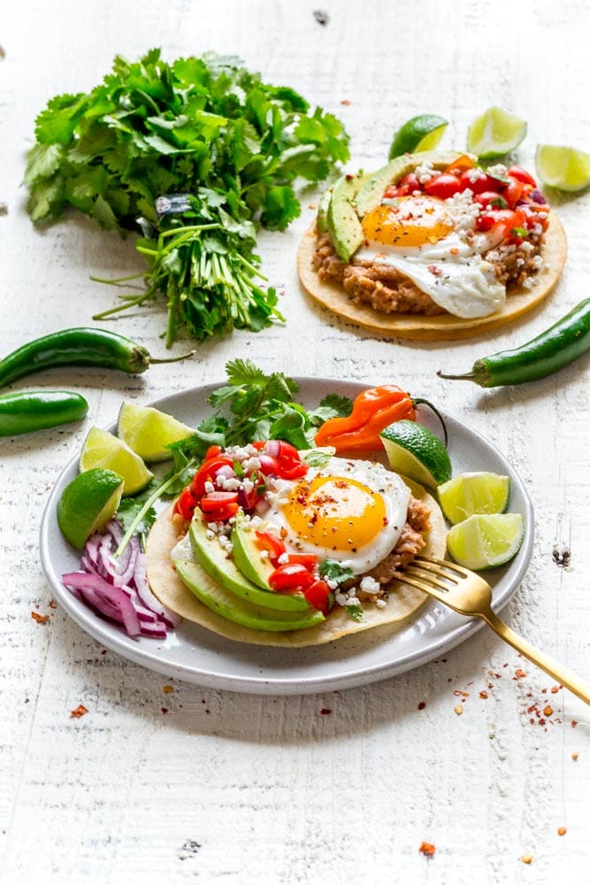 Huevos Rancheros on a plate with lime slices.