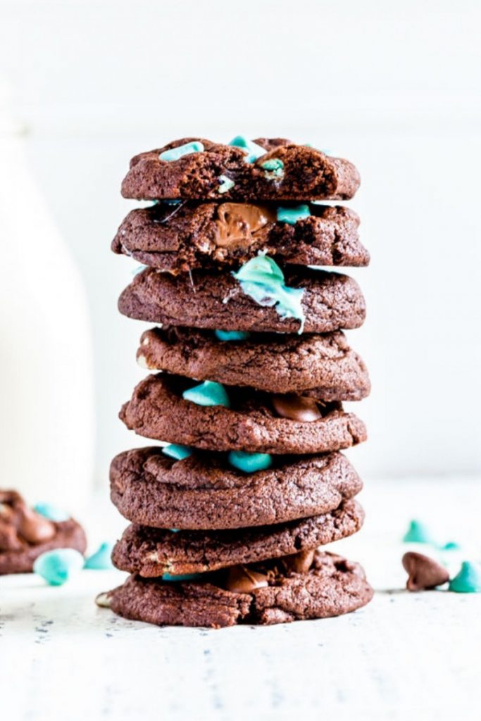 Mint chocolate chip cookies with a glass of milk.
