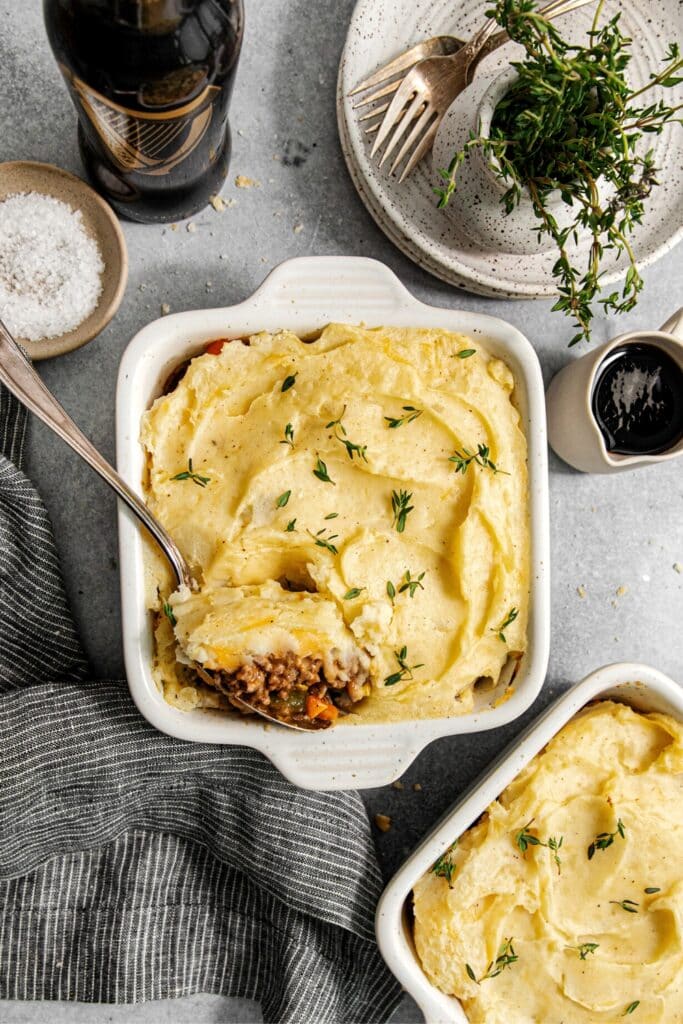 An Irish cottage pie made with Guinness stout beer on a serving table with a serving spoon.
