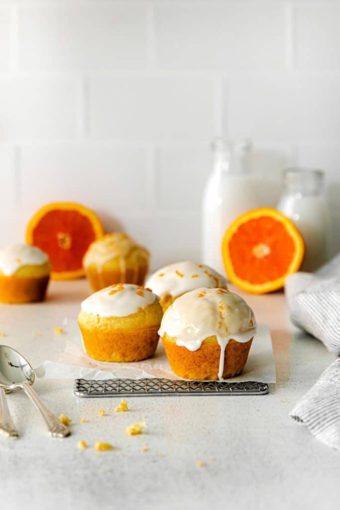 Fresh orange muffins with glaze sprinkled with orange zest.