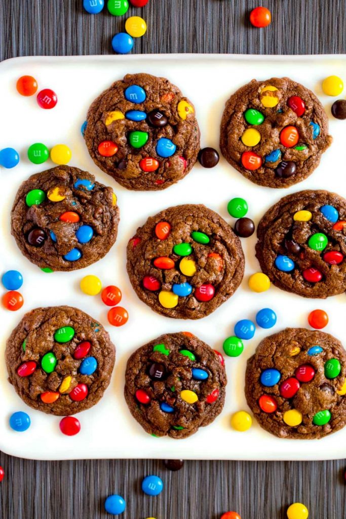 A white ceramic platter with freshly-baked M&M cookies