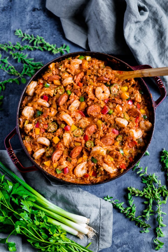 New Orleans Jambalaya served in a Staub universal pan with a wooden spoon.