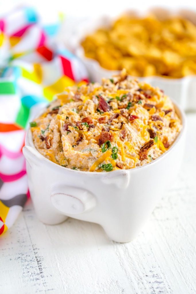 Cheesy Bacon Ranch Dip served in a cute bowl with a side of corn chips.