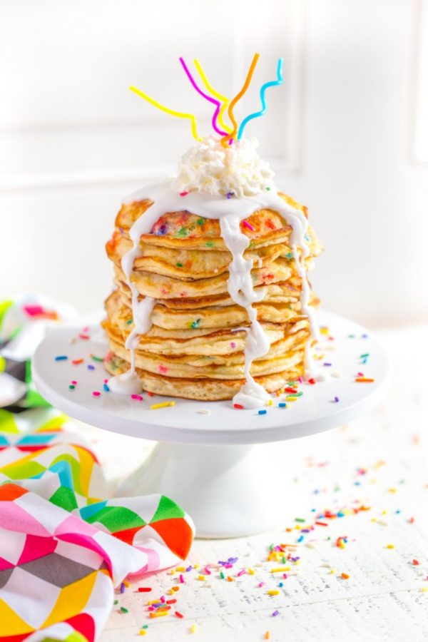 Funfetti Pancakes served on a white cake stand.