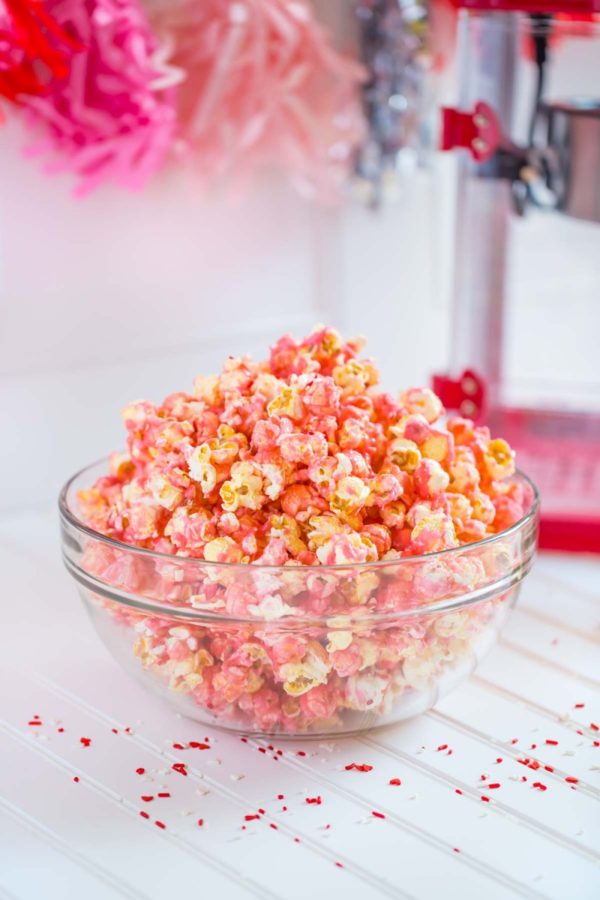 Pink Popcorn served in a clear glass bowl.