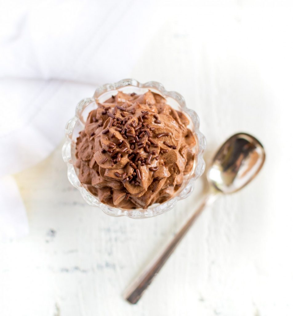 Chocolate mousse cup garnished with chocolate sprinkles.