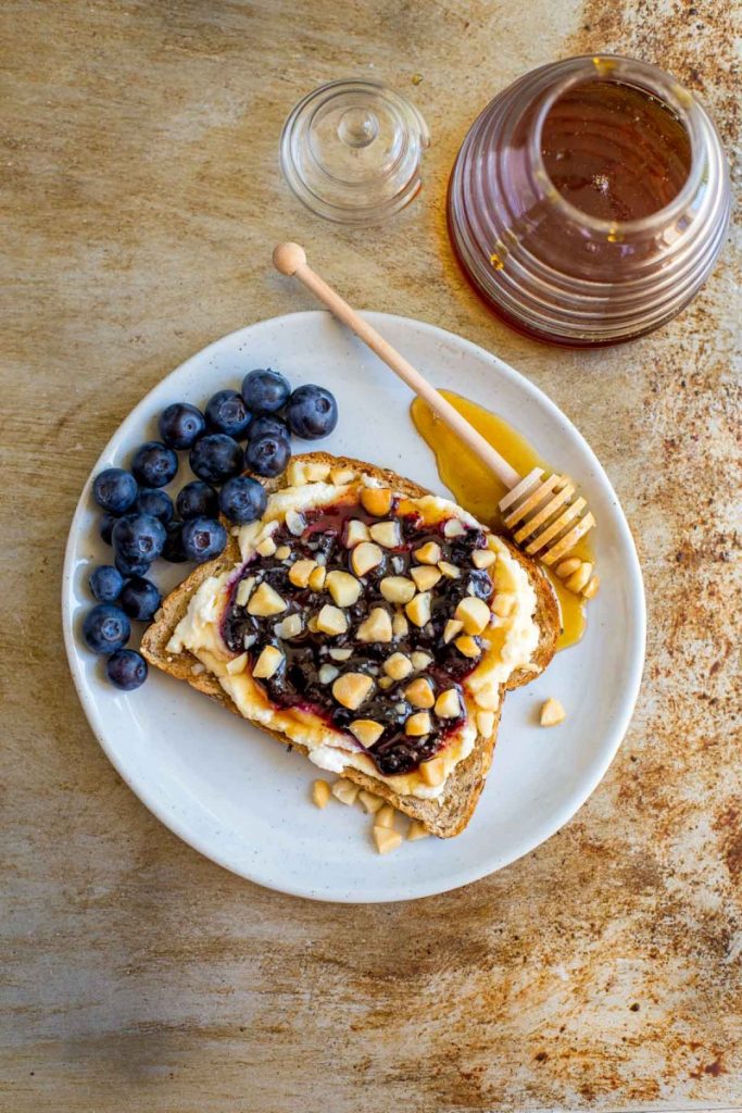 Breakfast Toast is a breakfast sandwich recipe made with ricotta, blueberry preserves, and honey.