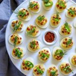 Deviled eggs on a white egg tray