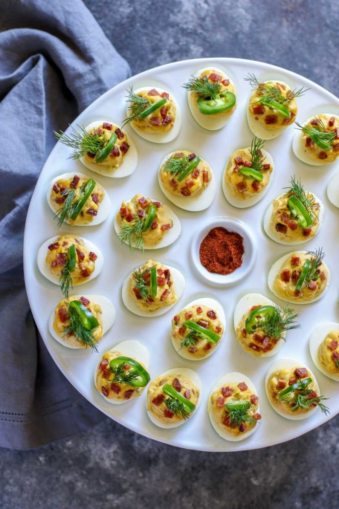 Deviled eggs on a white egg tray