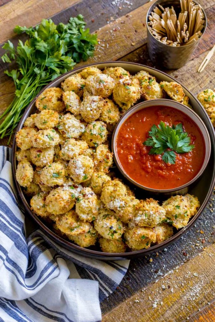 Tortellini Party Snacks in a serving bowl with a small bowl of marinara dipping sauce.