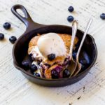 A serving of berry cobbler in a mini Lodge cast-iron pan.