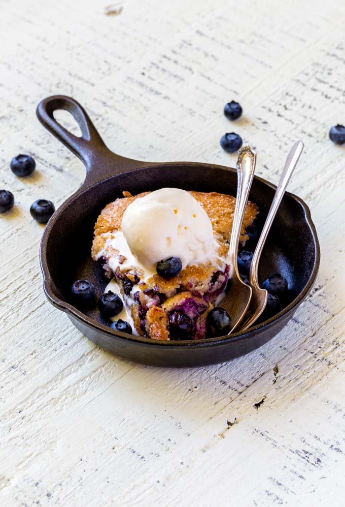 A serving of berry cobbler in a mini Lodge cast-iron pan.