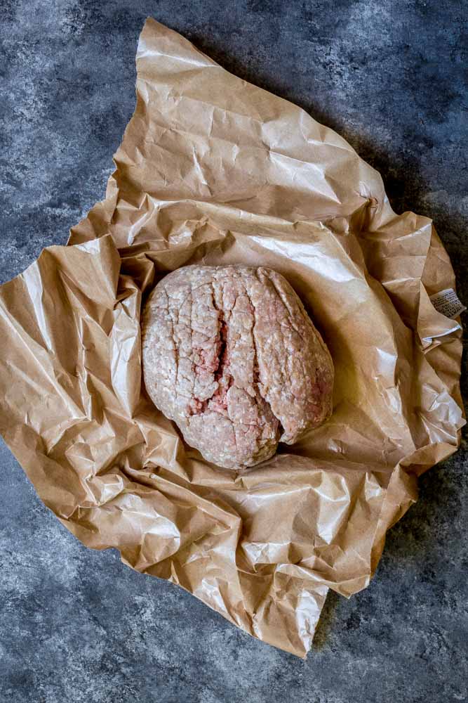 Fresh ground meat in butcher paper.