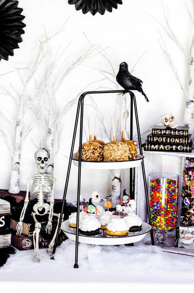 Caramel apples and cupcakes on a Halloween dessert table.