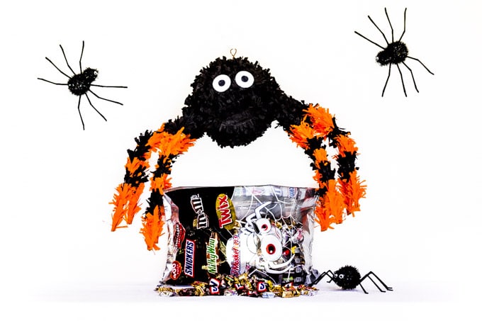 Halloween table with paper mache pinata and candy.
