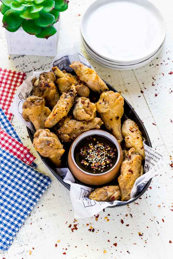 Fried chicken wings with Asian dipping sauce.