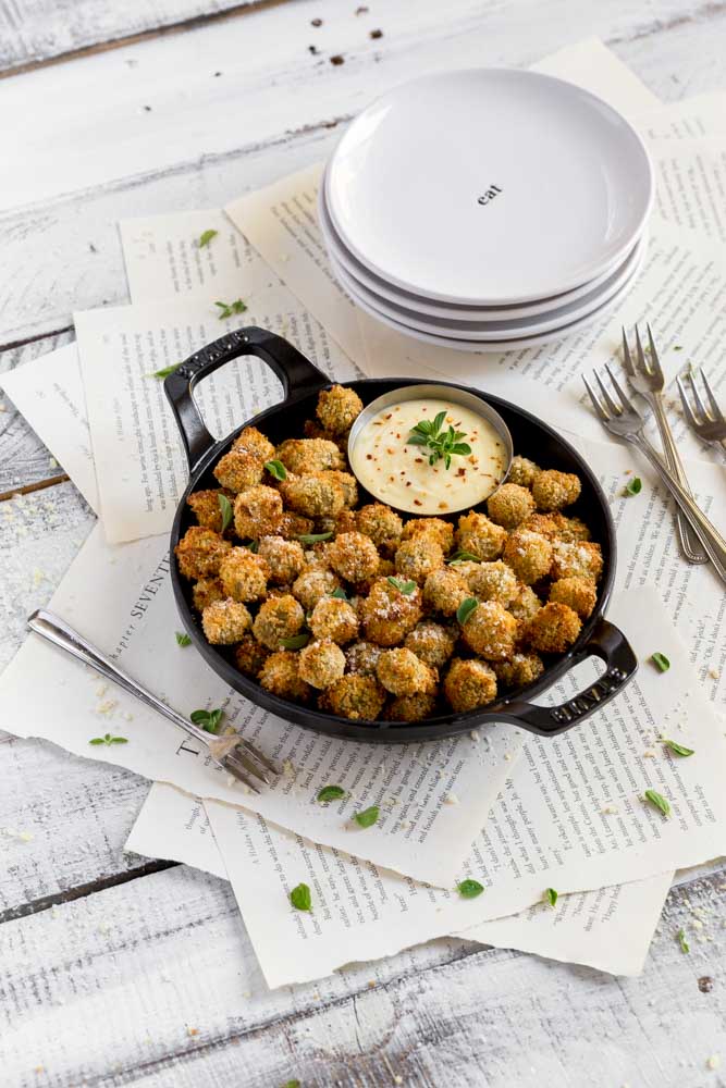Air fried appetizer served with dipping sauce inside a Staub cast-iron pan.