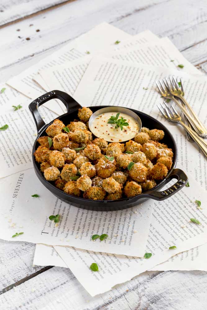 Fried Olives garnished with fresh oregano and Parmesan cheese.