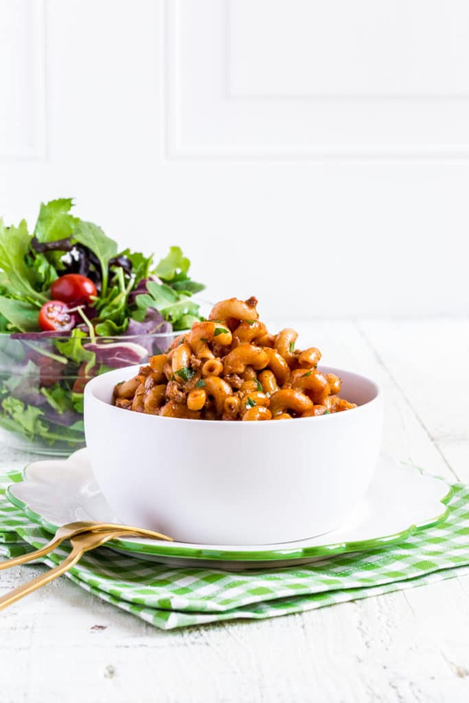 A single serving of Homemade Hamburger Helper. This cheesy taco pasta is served in a bowl.