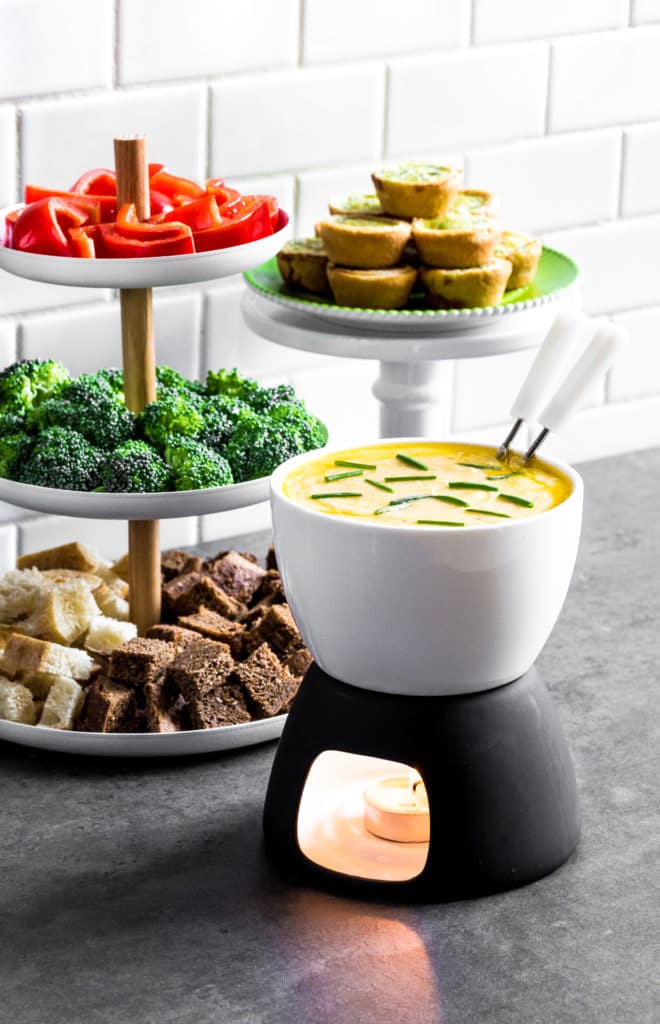 Cheese fondue served in a white Boska Holland fondue pot with black base and tea candle.
