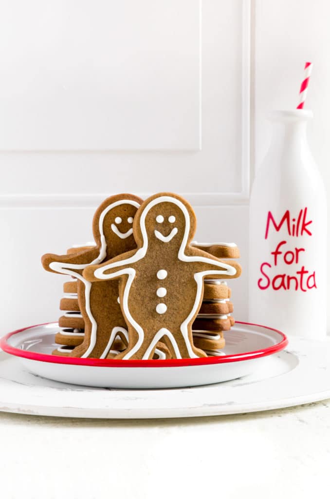 Christmas cookies on a plate next to a bottle of milk for Santa Claus.