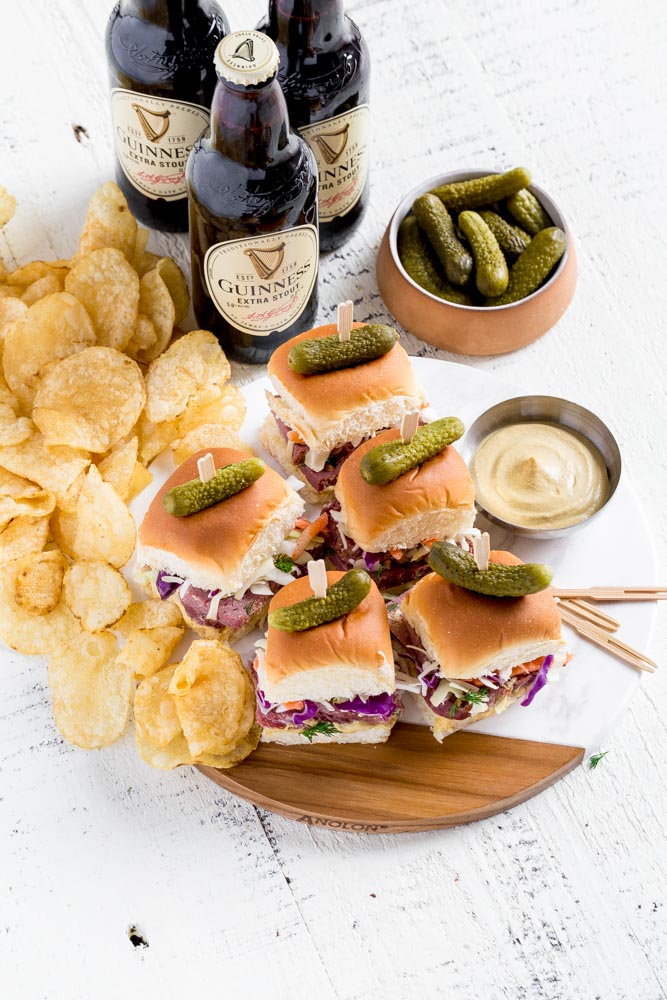 Corned Beef sliders served with dijon mustard and baby dill pickles.