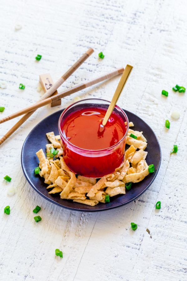 Sweet and Sour Sauce in a small clear-glass bowl with a tiny gold spoon.