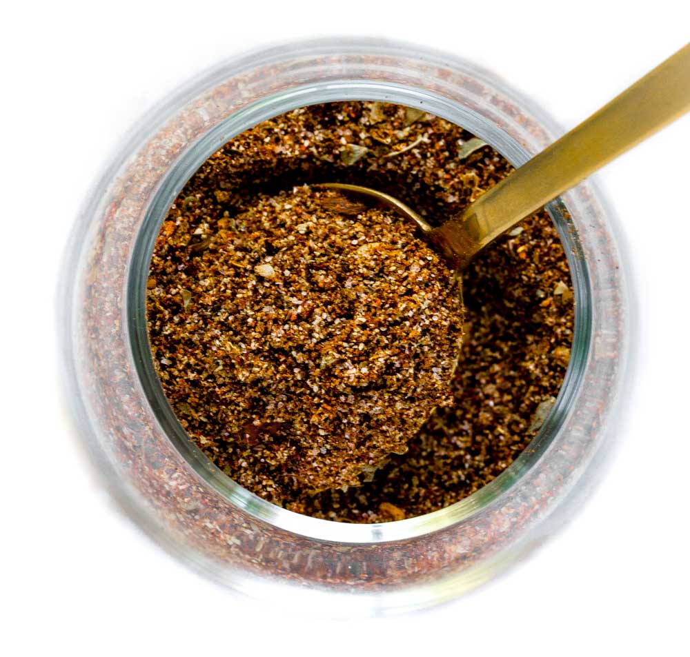 Top-down view of a glass jar with a unique spice blend for taco meat.