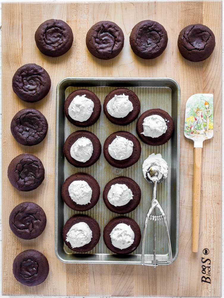 Large dollops of whoopie pie filling on mini chocolate cakes.