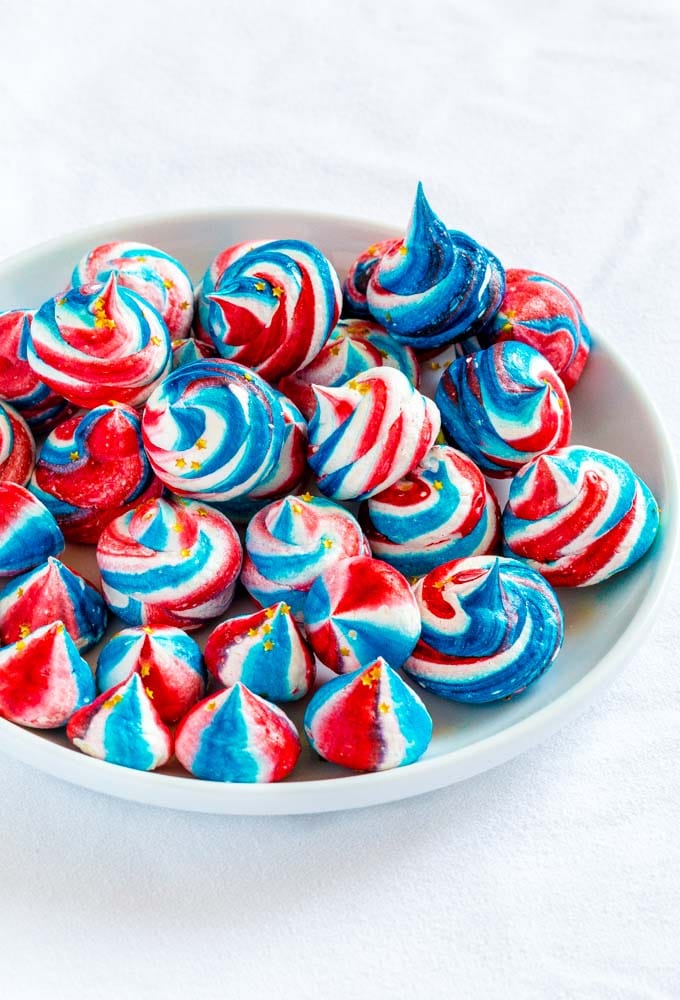 Red white and blue cookies for 4th of July on a small white serving plate.