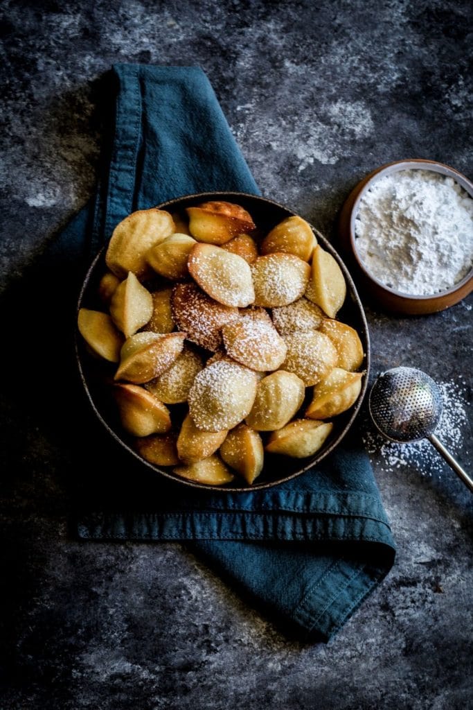 Iconic French Madeleines: golden blonde, lightly dusted with powdered sugar.