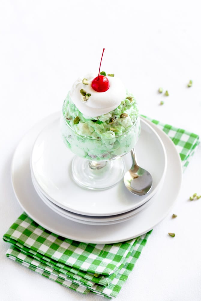 Individual serving of Watergate Salad dessert with a metal spoon.