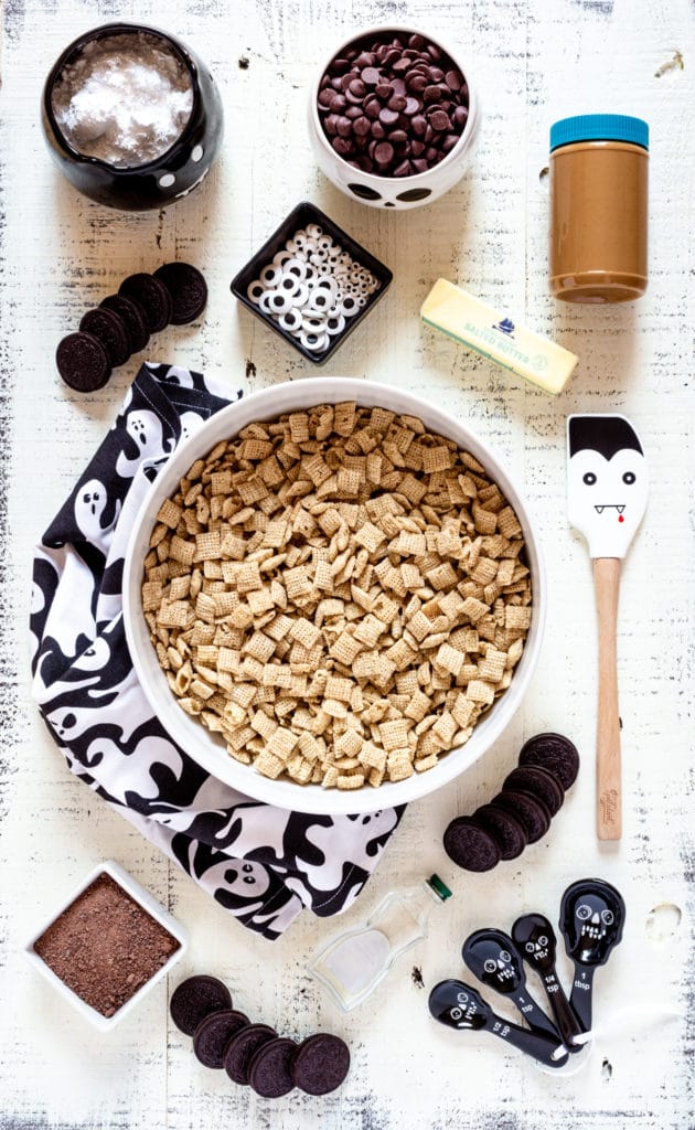 An overhead image of the ingredients needed to make Halloween Muddy Buddies Chex mix.