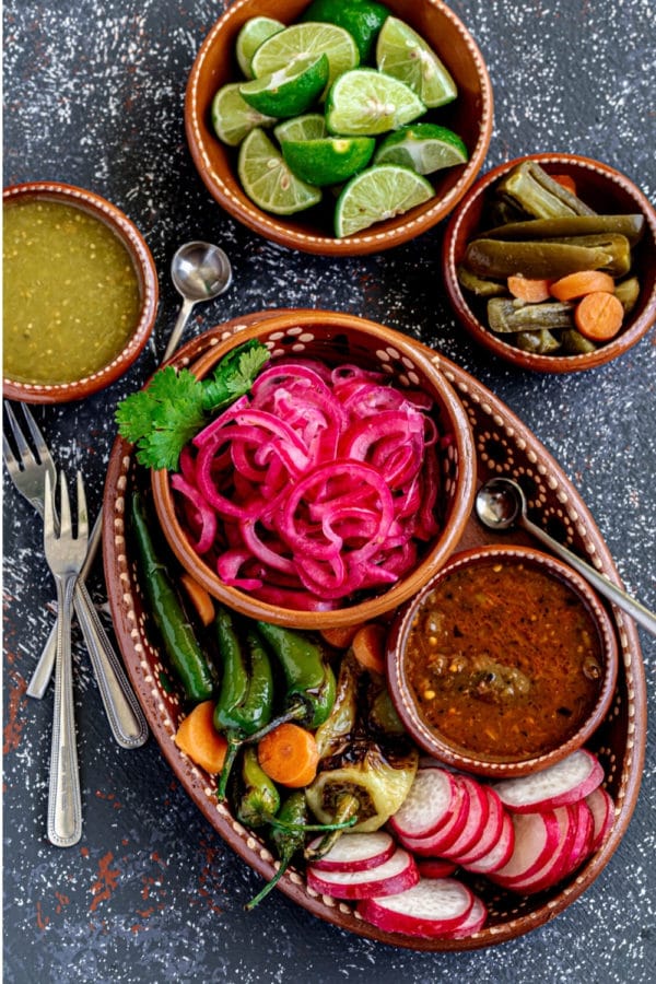 Mexican pickled onions served on a rustic clay condiment tray bought here in Mexico.