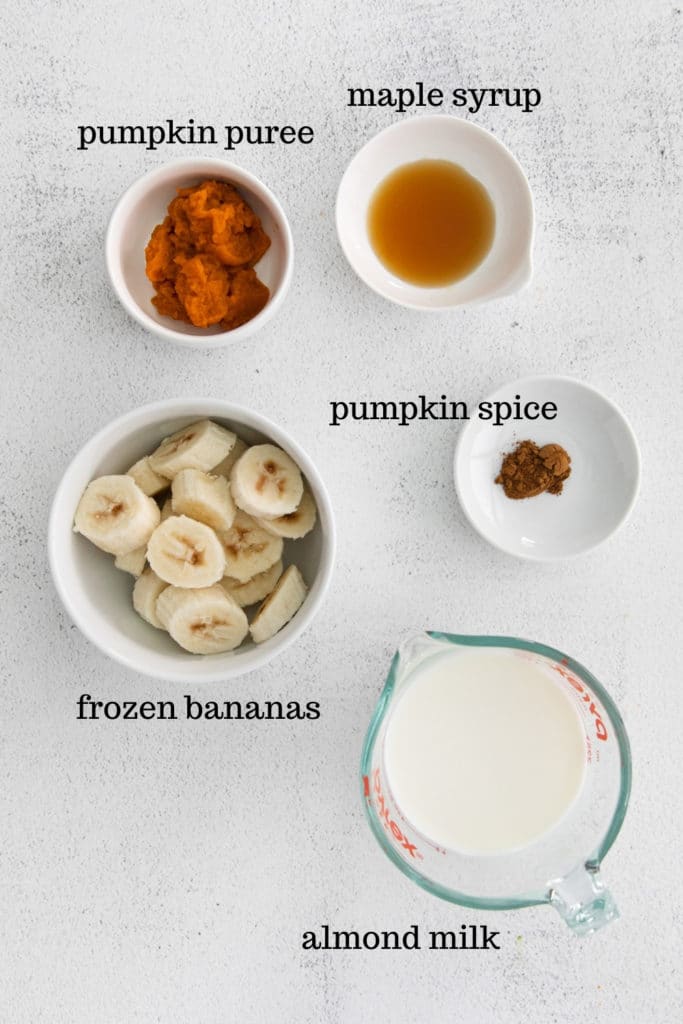 Ingredients for healthy pumpkin pie smoothie with pumpkin puree and frozen bananas.
