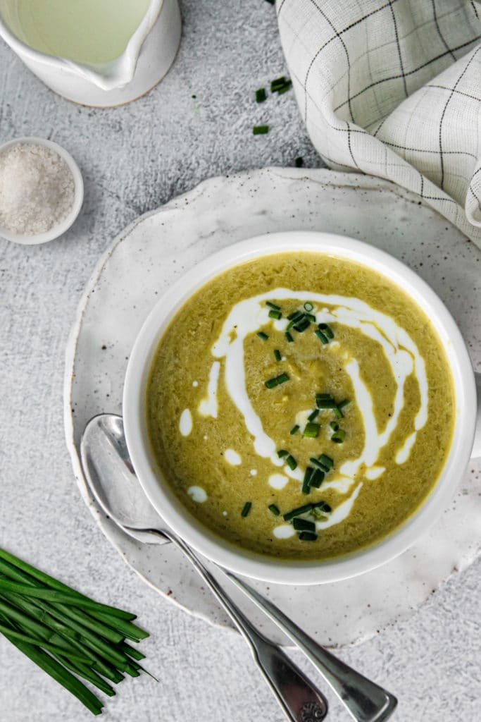 Cream of asparagus soup garnished with cream, salt and chives.