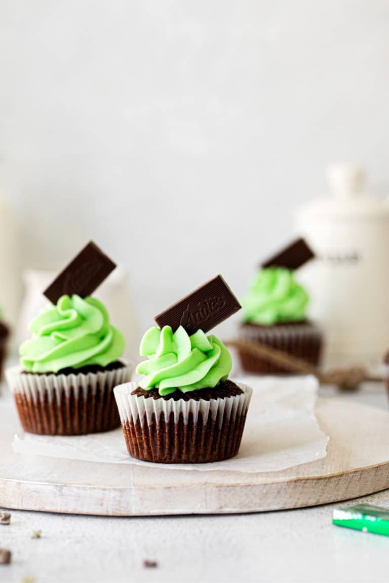 Andes Mint Chocolate Cupcakes on a white wooden board.