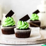 Andes Mint Chocolate Cupcakes on a white wooden board.
