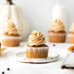 Pumpkin spice latte cupcake with espresso frosting on a mini plate.