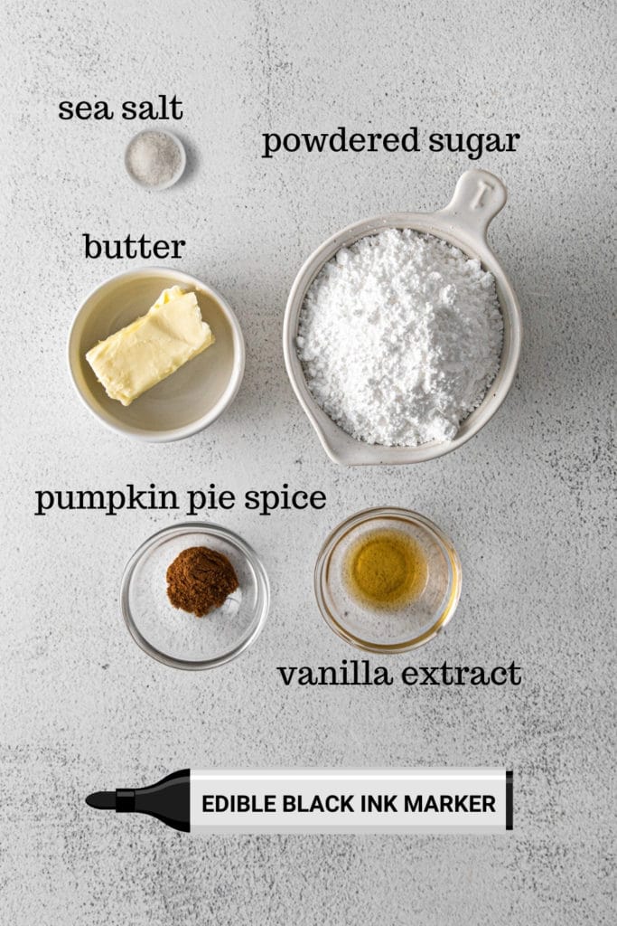 Ingredients for buttercream frosting plus edible black ink marker for decorating Halloween pumpkin macarons.